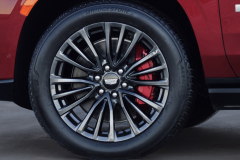 2023-Cadillac-Escalade-V-Press-Photos-Exterior-012-front-wheel-tire-red-brake-caliper-V-Series-logo-badge-on-door
