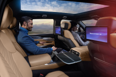 2025-Cadillac-Escalade-IQ-Sport-Reveal-Photos-Interior-014-rear-seat-headrest-screens-center-console-fold-out-table