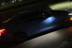 2022-Cadillac-CT4-V-Blackwing-GMA-Garage-Electric-Blue-Exterior-028-side-puddle-light-at-night