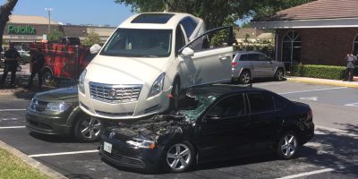 Cadillac XTS Reverses Through Intersections, Lands On Parked Cars: Video