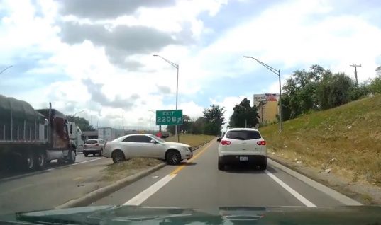 Cadillac CTS Tries To Escape Traffic, Gets Stuck: Video